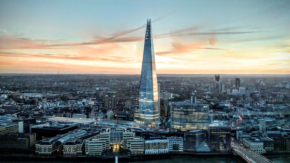 Luftaufnahme des gläsernen Turms von The Shard, der sich bei Sonnenuntergang über die Skyline von London erhebt