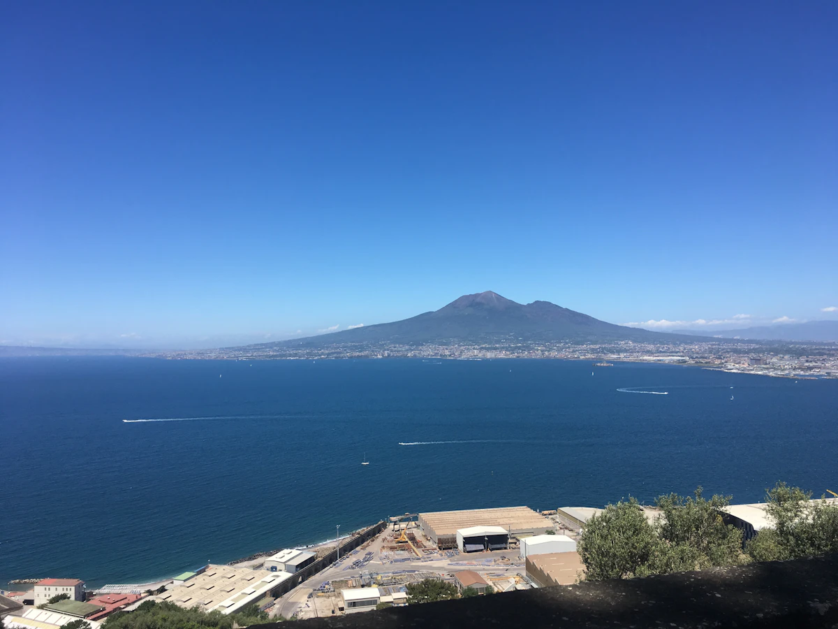 Mount Vesuvius overlooking the Bay of Naples under a blue sky
